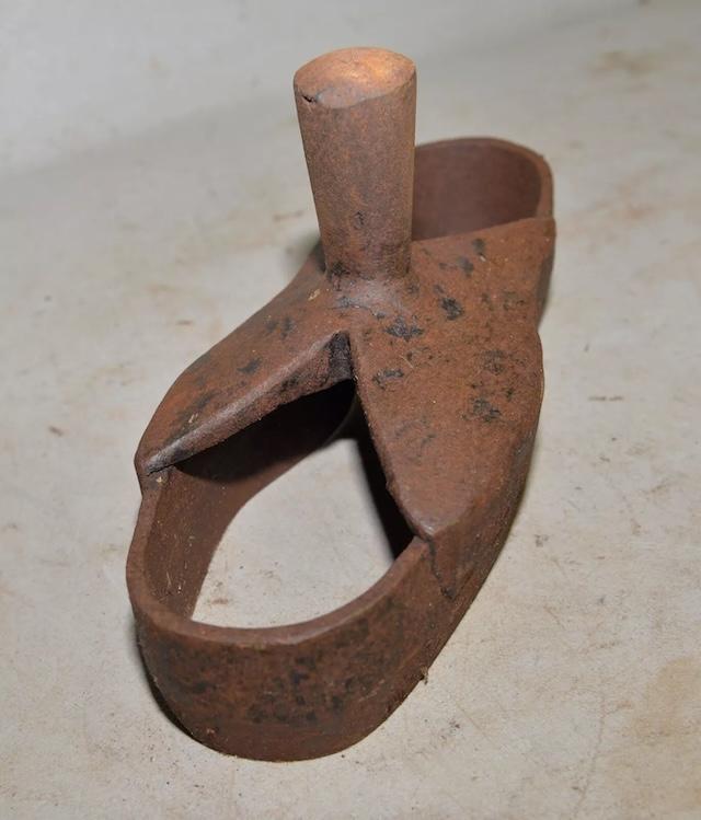 A top view of the antique steel shoe sole die cutter, showcasing its rugged design used for shaping shoe soles